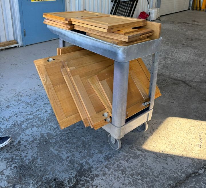 Cabinet doors staged for refinishing by Maple City Painters